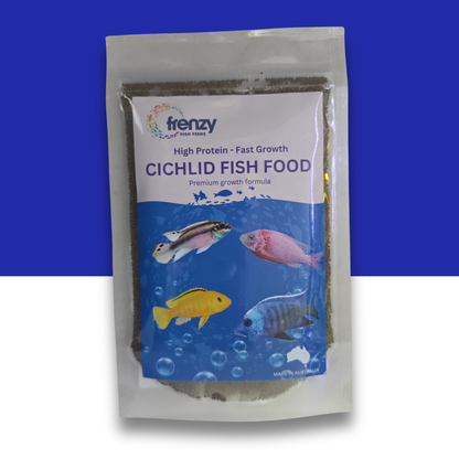 A stand-up pouch of Frenzy Cichlid Fish Food, featuring a blue and white label with illustrations of four colorful cichlids. The pouch is set against a split blue and white background.