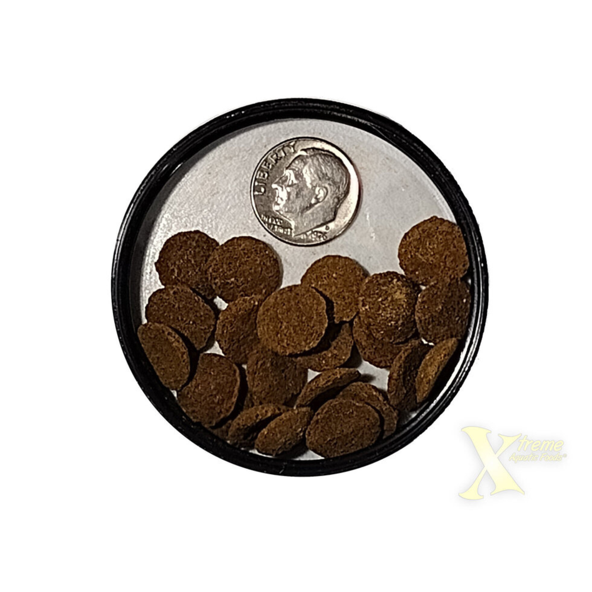Small round container with xtreme Aquatic Foods bottom wafers and a quarter for scale on a white background