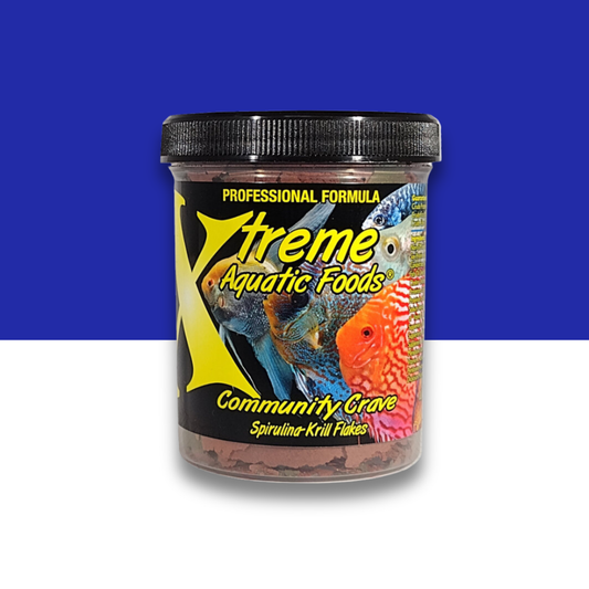Container of Xtreme Aquatic Foods Community Crave fish food with colorful fish illustration on a blue and white background